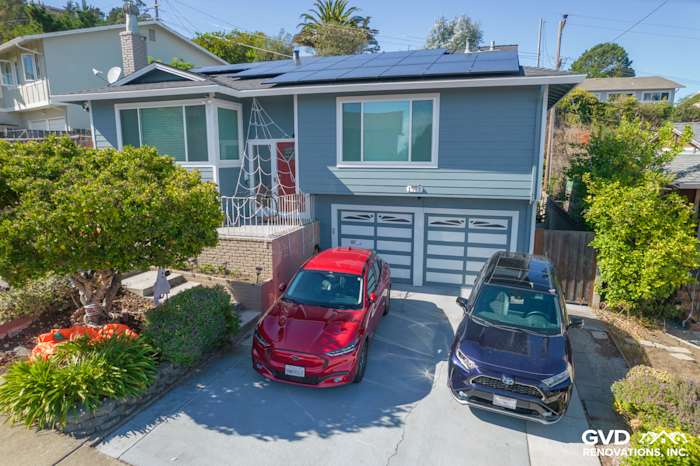 Home exterior remodel in San Bruno with Boothbay Blue siding, Arctic White trim, and solar panels
