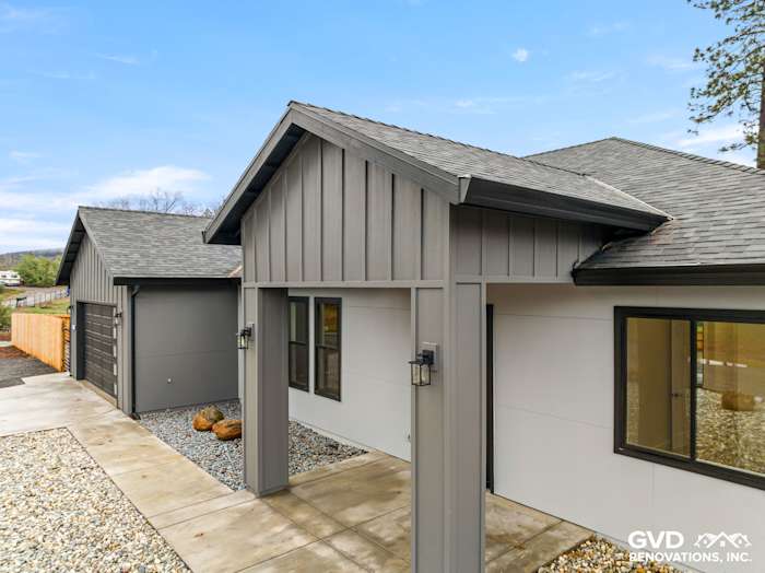 Modern home exterior in Paradise, CA featuring James Hardie Sea Grass panels and Milgard black windows
