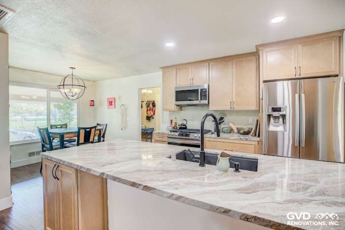 Modern kitchen remodel featuring quartz countertop, stainless steel appliances, and warm wood cabinetry in Sacramento home