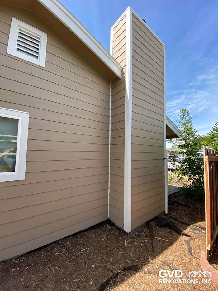 Khaki brown James Hardie lap siding with Arctic white trim on Fairfield home exterior, showcasing chimney area