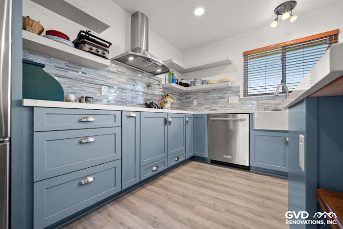 Modern kitchen remodel featuring blue Waypoint cabinets, MSI Calacatta Ultra countertops, and Misty Fjord backsplash in Elk