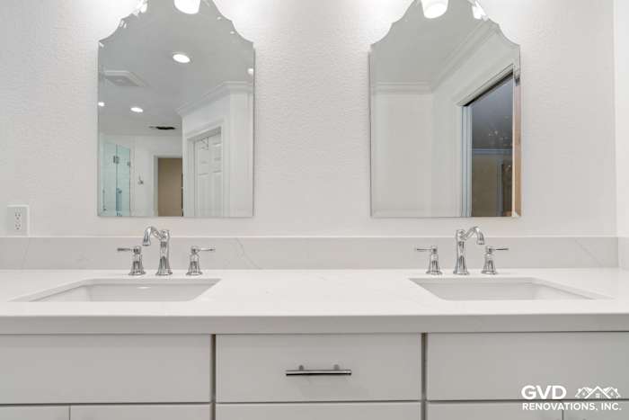 Bright bathroom vanity with double sinks, quartz countertop, and elegant mirrors in Fair Oaks remodel