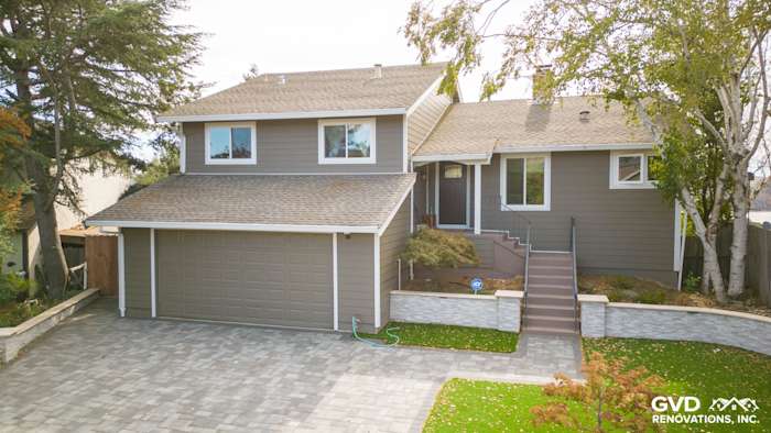 Home exterior featuring Timber Bark HardiePlank siding and Arctic White trim in Benicia, CA. Modern landscaping and driveway