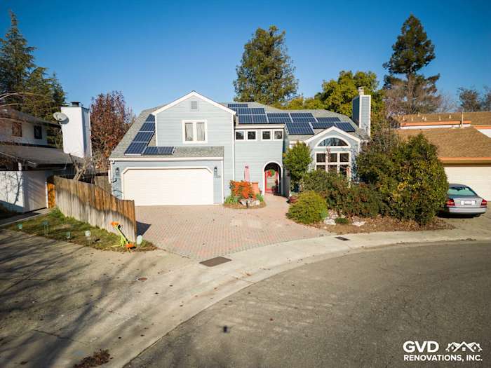 Davis home exterior showcasing James Hardie Boothbay Blue siding, solar panels, and landscaped front yard