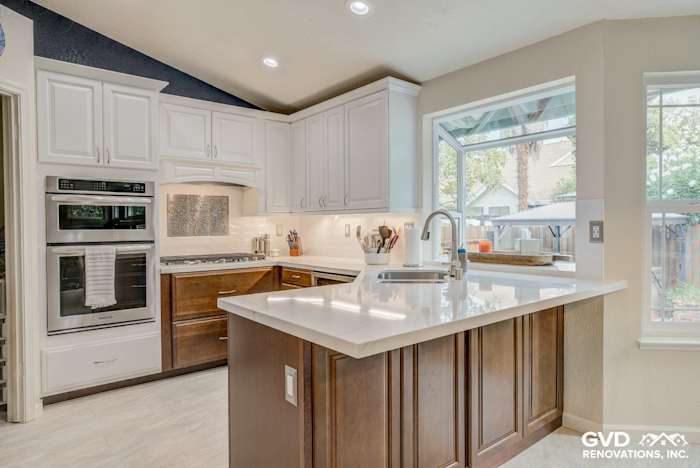 Modern kitchen remodel with white cabinetry, quartz countertop, stainless steel appliances, and large window in Elk Grove