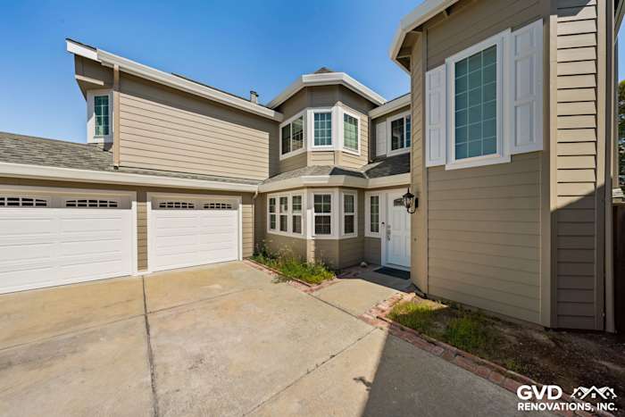 Modern home exterior featuring Monterey Taupe James Hardie Lap Siding and Arctic White Mezzo Windows in Foster City