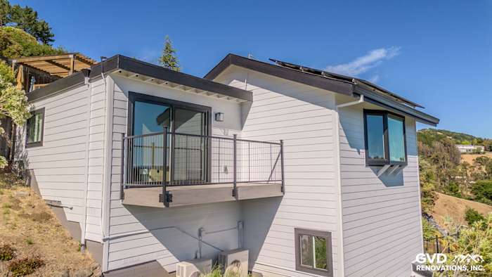 Modern home exterior featuring Arctic White James Hardie siding and Anlin Catalina windows with a balcony in San Rafael