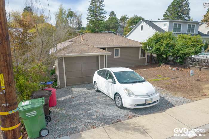 Home exterior in Mill Valley featuring Prodigy Solid Core Siding in a neutral tone and gravel driveway