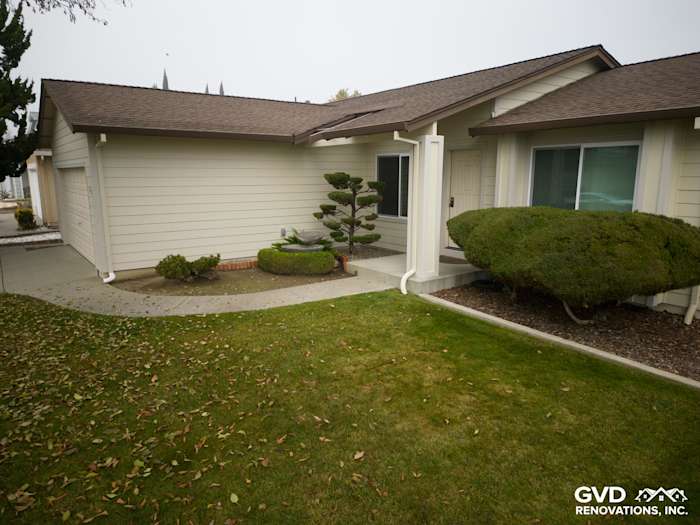 Exterior of a home featuring James Hardie Navajo Beige Lap Siding with Cobble Stone HardieTrim, landscaped yard in Suisun