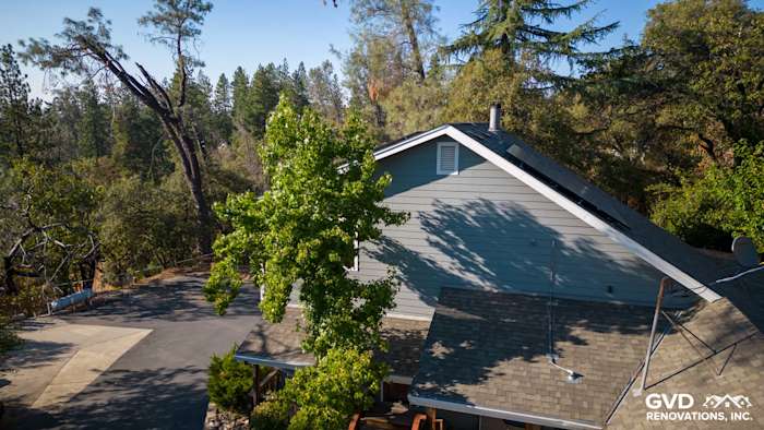 Home exterior featuring Gray Slate James Hardie siding and Arctic White trim, surrounded by trees in Colfax, CA