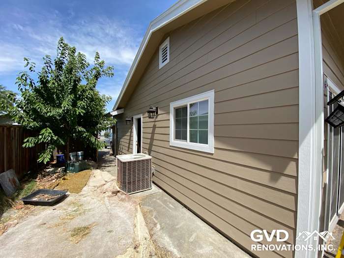 Khaki brown James Hardie lap siding installed on home exterior with Arctic white trim in Fairfield, CA