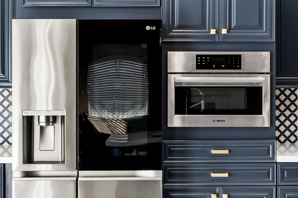 Modern kitchen remodel featuring navy blue cabinets, white quartz countertops, and patterned backsplash in Sacramento