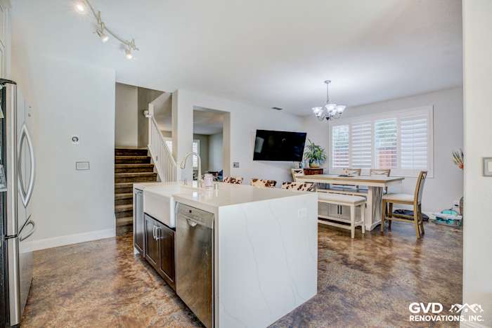 Modern kitchen remodel in Roseville featuring quartz island, stainless steel appliances, and open dining area