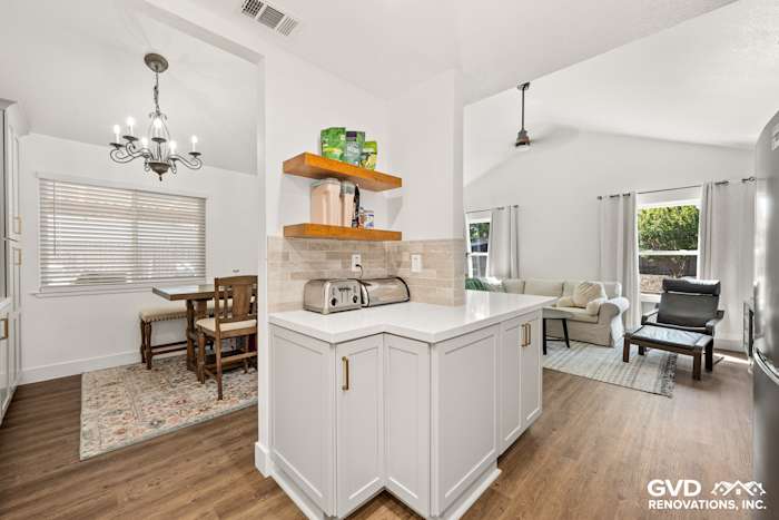 Modern kitchen in Roseville with Waypoint Painted Harbor cabinetry, Vadara Naurelle countertops, and floating shelves