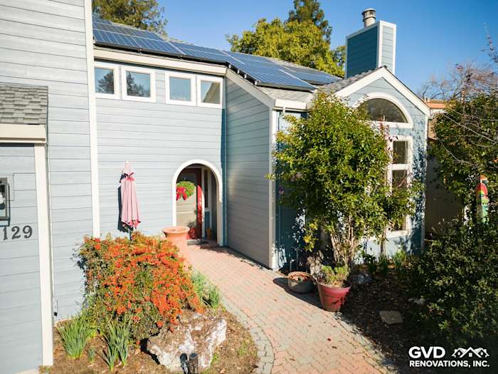 Home exterior featuring new Boothbay Blue James Hardie siding, solar panels, and landscaped entryway in Davis, CA