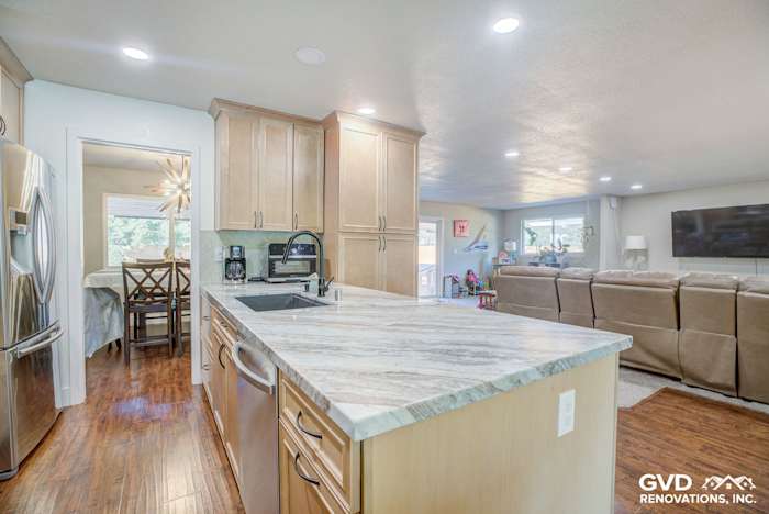 Bright modern kitchen featuring light wood cabinetry, quartz countertop, and stainless steel appliances in Sacramento home
