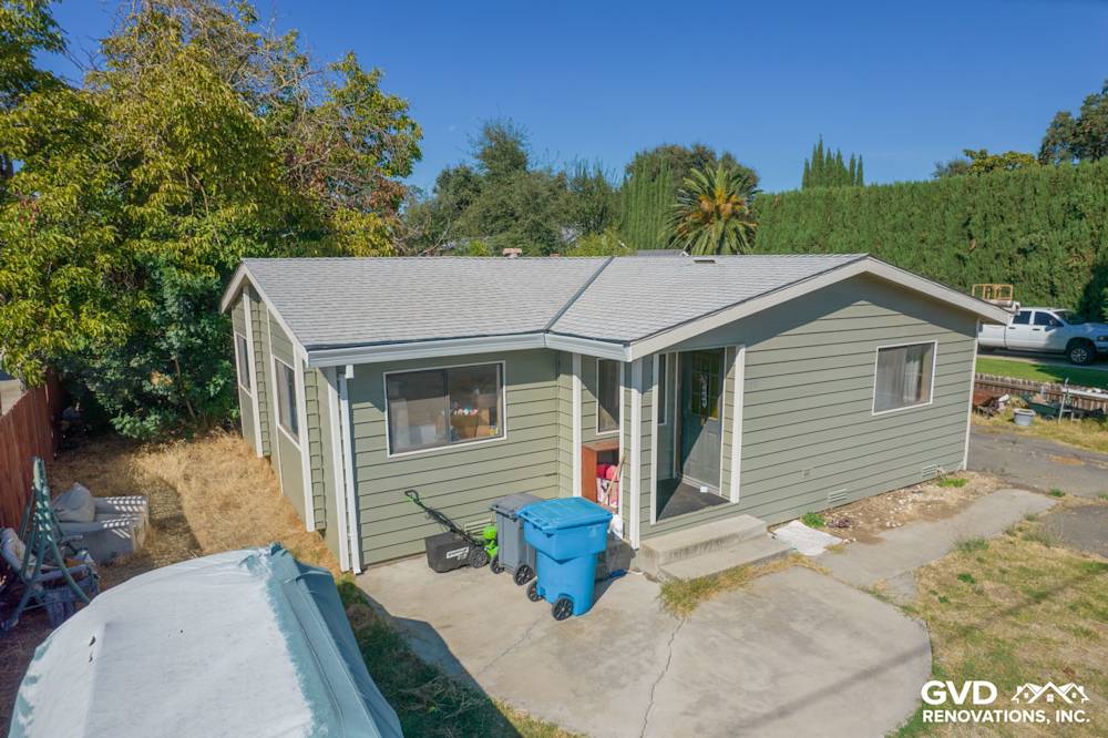 Siding replacement project in Yuba City featuring green Prodigy Siding and a modern roof design