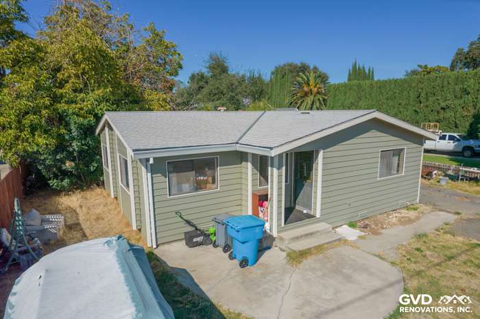Siding replacement project in Yuba City featuring green Prodigy Siding and a modern roof design