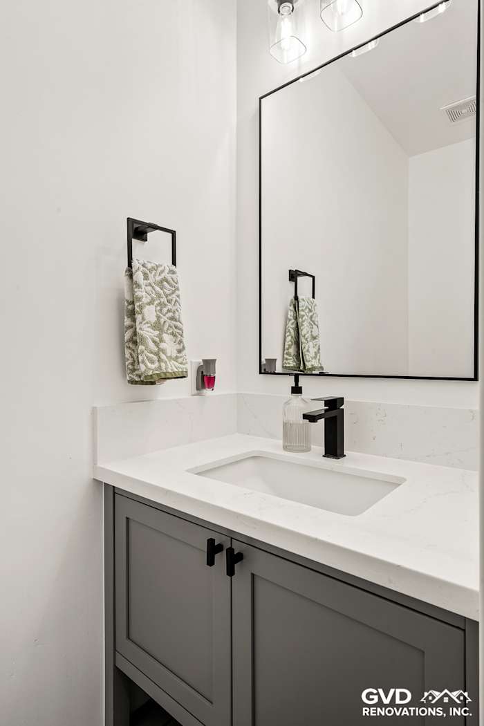 Modern bathroom remodel featuring a sleek vanity, quartz countertop, and decorative mirror in Antelope, CA
