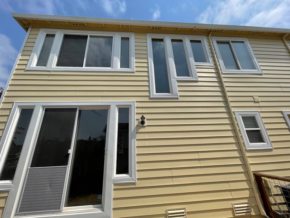 Elevated view of a light yellow exterior with various window styles in Sacramento