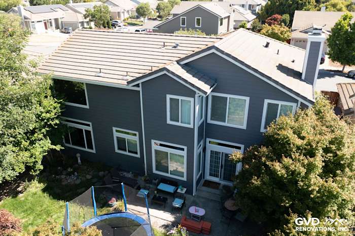 Modern home exterior in Petaluma featuring Night Grey James Hardie siding and Arctic White trim, with landscaped yard