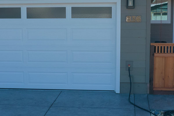 Coastal home exterior with Timber Bark siding, Arctic White trim, new garage door, and landscaped pathway in Pacifica