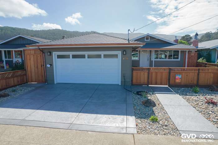 Coastal home exterior with Timber Bark siding, Arctic White trim, new garage door, and landscaped pathway in Pacifica