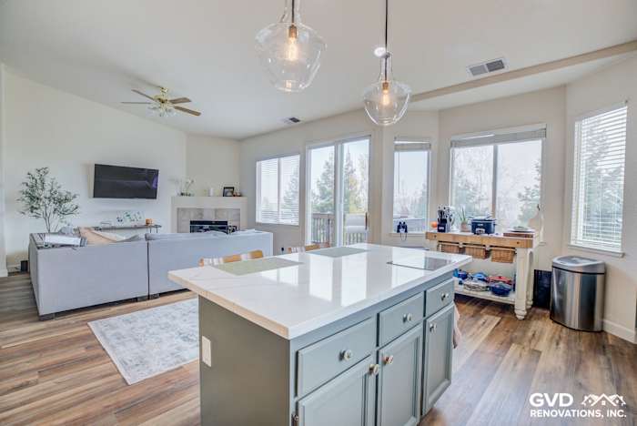Bright kitchen featuring a white quartz island, gray cabinetry, and large windows in El Dorado Hills