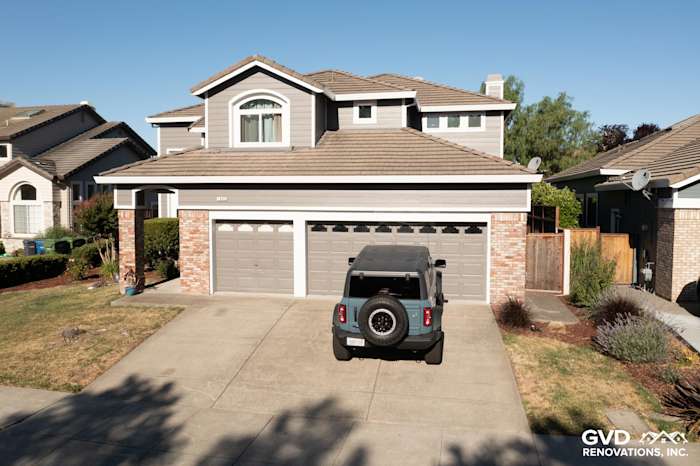 Home exterior featuring James Hardie Aged Pewter lap siding, Alside Mezzo windows, and brick accents in Petaluma, CA