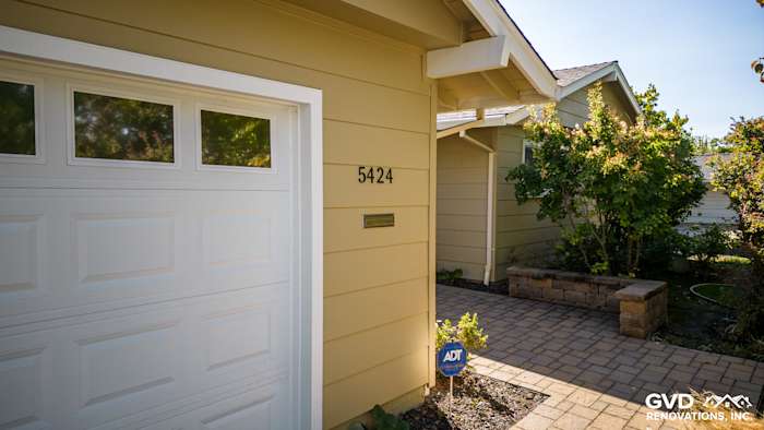 Carmichael home with James Hardie siding, featuring HardiePlank in beige and a brick pathway