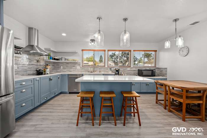 Modern Elk Grove kitchen remodel featuring blue Waypoint Cabinets, Calacatta Ultra countertops, and Misty Fjord backsplash