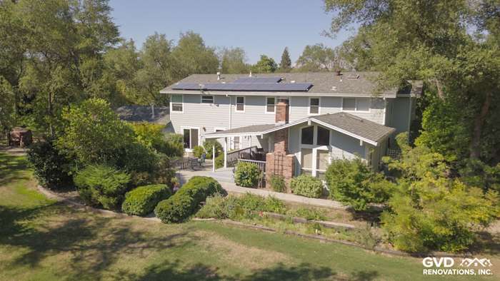Granite Bay home exterior featuring Light Mist James Hardie siding and Arctic White trim with lush landscaping