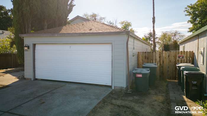Home exterior with newly installed James Hardie siding, featuring a modern garage and minimal landscaping