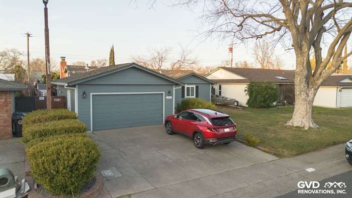 Home exterior in Rancho Cordova with Boothbay Blue James Hardie siding and freshly painted eaves. Red SUV parked in driveway