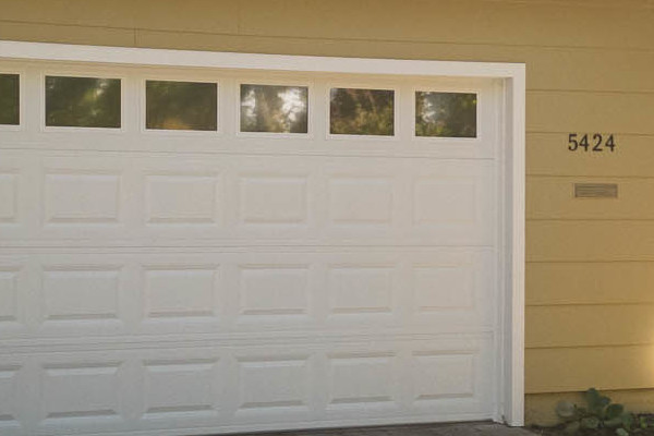 Updated home exterior featuring new James Hardie siding and HardiePlank trim in a muted beige color