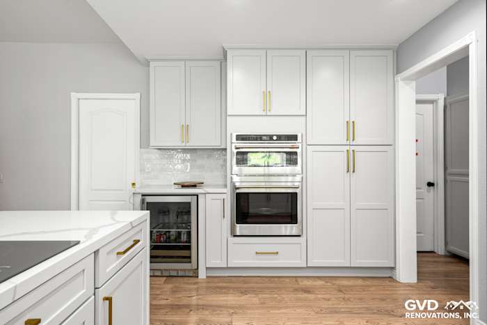 Modern El Dorado Hills kitchen with white custom cabinets, quartz countertops, and stainless steel appliances