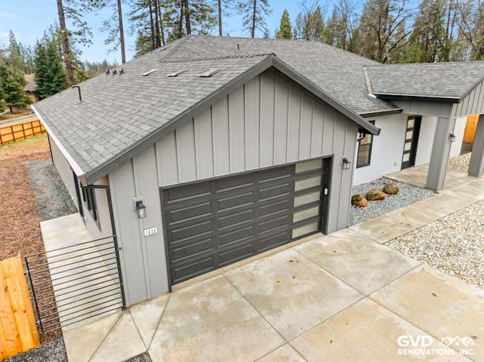 New construction home in Paradise, CA with James Hardie siding, black Milgard windows, and modern garage door