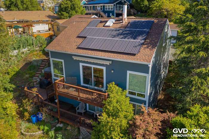 Exterior upgrade featuring James Hardie lap siding, solar panels, and a wooden deck in Oakland, CA