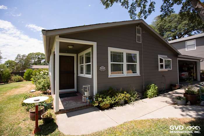 Auburn home with Aged Pewter HardiePlank siding and Arctic White trim, featuring a neat porch and garden