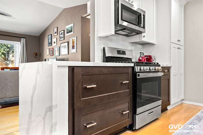 Modern kitchen featuring dark wood cabinetry, stainless steel appliances, and white quartz countertop in Davis, CA