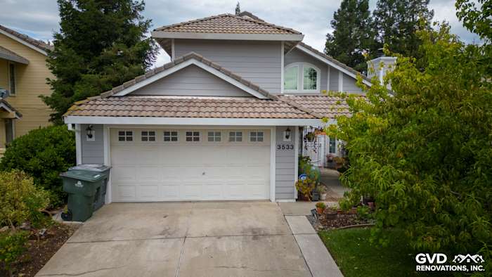 Home exterior featuring James Hardie Pearl Gray siding with Arctic White trim and a tile roof in Rocklin, CA