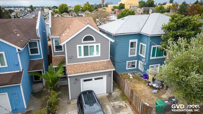 Home exterior in Oakland featuring Aged Pewter James Hardie siding and Arctic White HardieTrim on a renovated house