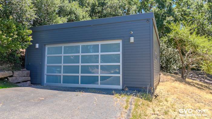 Lafayette home featuring James Hardie Night Gray siding and modern glass garage door