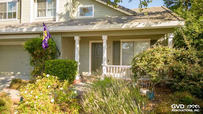 Evening Blue HardiePlank siding and Arctic White trim on a Petaluma home exterior with landscaping and porch