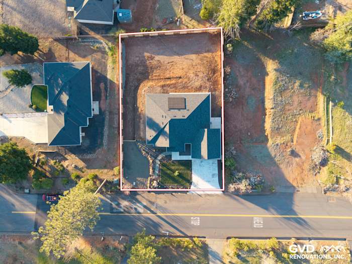 Aerial view of a custom-built home in Paradise, CA, showcasing James Hardie siding and landscaped surroundings