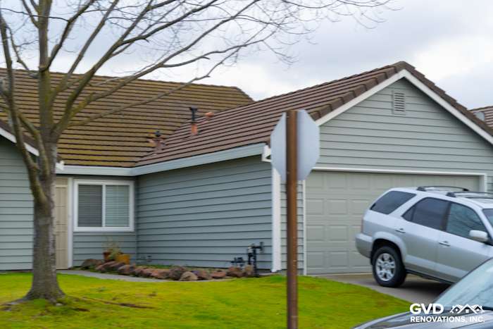 Home exterior featuring Prodigy Solid Core Insulated Siding in light gray, with painted eaves and a garage