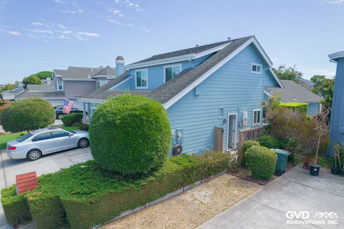 Blue James Hardie siding renovation with Alside windows and manicured landscaping in Foster City, CA
