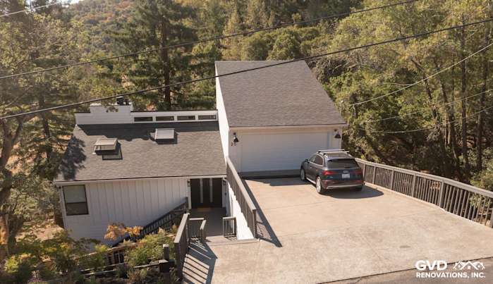 Modern home exterior featuring Arctic White James Hardie siding and trimmed roof with driveway in Novato, CA