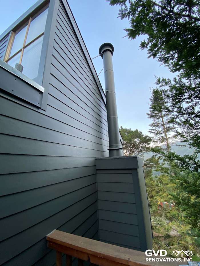 Dark gray James Hardie siding on home exterior with chimney and trees in background, Mill Valley, CA