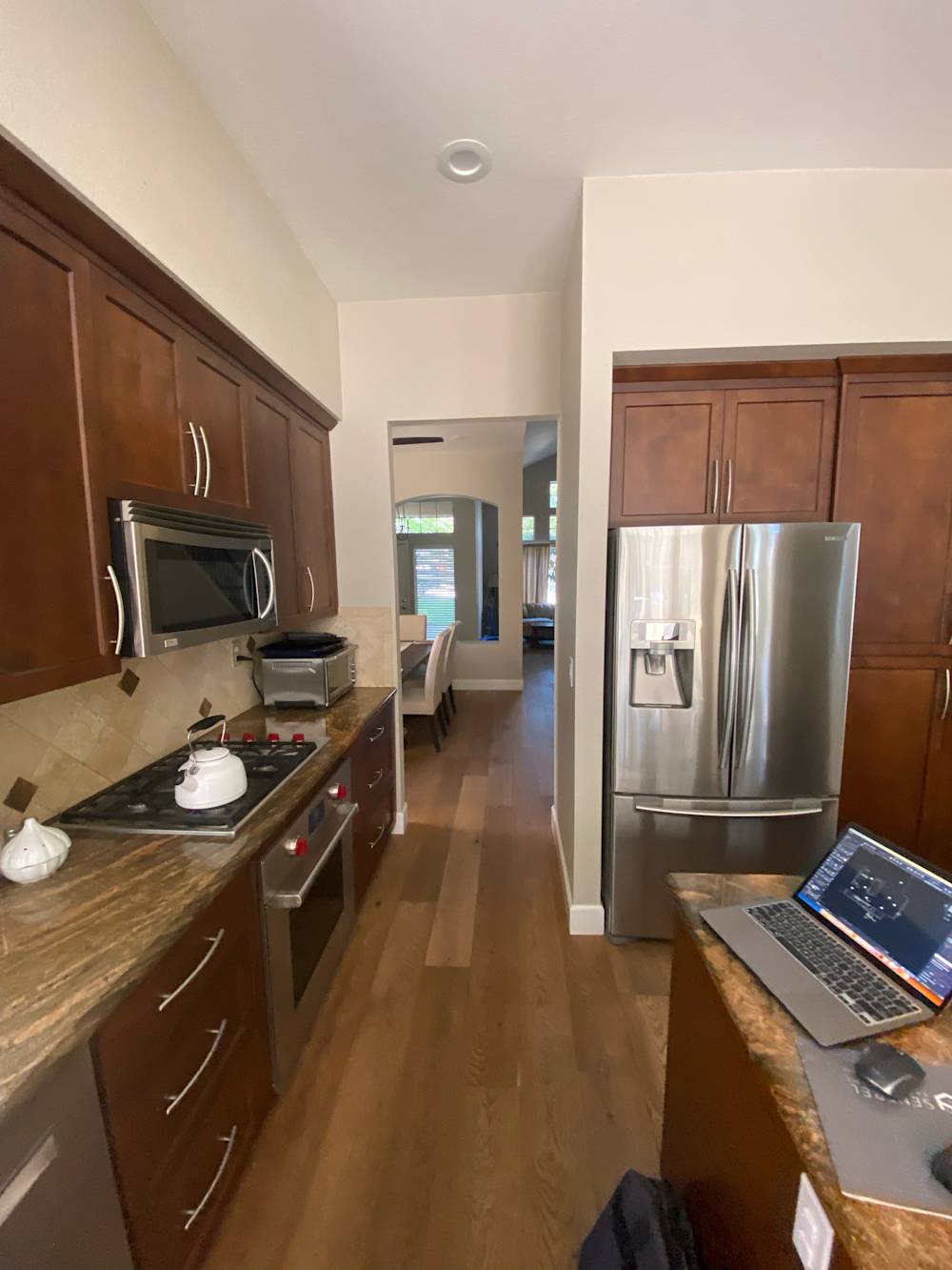 Dark wood cabinets and brown countertops in a narrow Sacramento kitchen